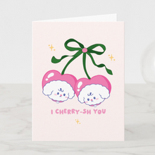 Load image into Gallery viewer, A cute birthday greeting card featuring Bibo the dog peeking out of a large strawberry with a pink bow, with the text 'Have a Berry Happy Birthday!' on a light pink background.