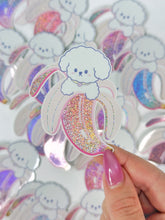 Load image into Gallery viewer, Sticker of a white dog with a rainbow-colored ice cream cone held by a hand.