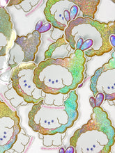 Load image into Gallery viewer, Sticker design of a white dog with colorful, glittery borders on a white background.