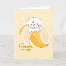 Load image into Gallery viewer, A sweet greeting card featuring Bibo the dog character peeking out of a peeled yellow banana, accompanied by the hand-lettered text 'I'm Bananas For You' on a soft yellow background.