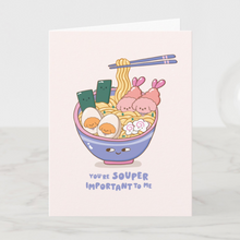 Load image into Gallery viewer, A playful greeting card showing a blue ramen bowl filled with Bibo characters as tempura and fish cakes, with the punny text 'You're Souper Important To Me' below.