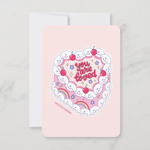 Load image into Gallery viewer, A heart-shaped pink cake mini art print decorated with Bibo dog characters as frosting dollops and cherries, featuring the bubble letter text 'You Are Loved'.